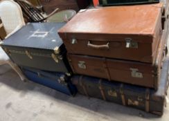 Two cabin trunks together with two steamer trunks and a leather suitcase