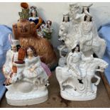 Two Staffordshire pottery figural spill vases together with a Staffordshire spaniel and a