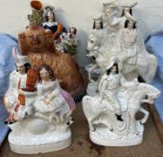 Two Staffordshire pottery figural spill vases together with a Staffordshire spaniel and a