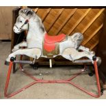 A sprung tin plate rocking horse on an X framed base