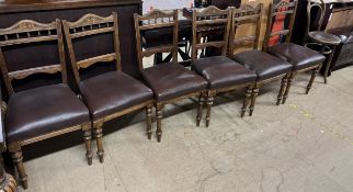 A set of six Edwardian dining chairs with pad upholstered seat on turned legs together with a