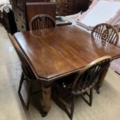 An Edwardian mahogany extending dining table on turned tapering legs and casters with an additional