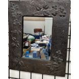 A copper wall mirror, decorated with fruit and leaves, 42.5 x 35.