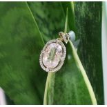 Gemporia - A 9ct gold kolum kunzite and diamond pendant, set with oval kunzite and round diamonds,