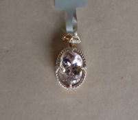 Gemporia - A 9ct gold kolum kunzite and diamond pendant,