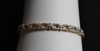 Gemporia - A 9ct gold Tomas Rae diamond bracelet, set with round cut diamonds totalling 1.