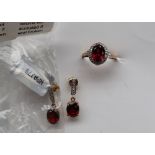 Gemporia - A 9ct garnet and white zircon ring, set with oval cut garnets and round white zircons,