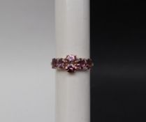Gemporia - A 9ct gold purple spinel and diamond ring,