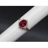 Gemporia - A 9ct gold garnet and white zircon ring,