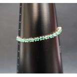 Gemporia - A 9ct gold Tomas Rae emerald slider bracelet, set with oval emeralds totalling 3.