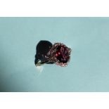 Gemporia - A 9ct gold garnet and white zircon ring, set with oval garnets and round white zircons,