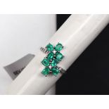 Gemporia - A 9ct white gold emerald and white zircon ring,