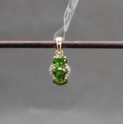 Gemporia - A 9ct gold chrome diopside and diamond pendant,