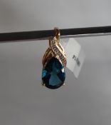 Gemporia - A 9ct gold topaz and diamond pendant, set with pear shaped blue topaz and round diamonds,