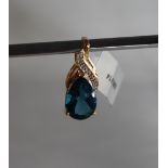 Gemporia - A 9ct gold topaz and diamond pendant, set with pear shaped blue topaz and round diamonds,