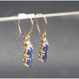 Gemporia - A pair of 9ct gold blue sapphire and diamond earrings,