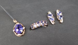 Gemporia - A 9ct gold tanzanite and diamond pendant, set with oval tanzanite and round diamonds,