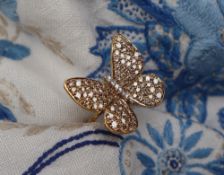 Gemporia - A 9ct gold butterfly ring, set with round cut diamonds totalling 1.