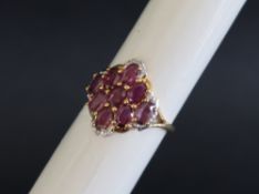 Gemporia - A 9ct gold ruby and diamond ring, set with oval cut Sant rubies and round cut diamonds,