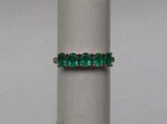 Gemporia - A 9ct gold emerald ring, set with oval emeralds totalling 1.