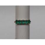 Gemporia - A 9ct gold emerald ring, set with oval emeralds totalling 1.