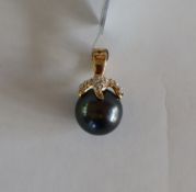 Gemporia - A 9ct gold cultured pearl and white zircon pendant,