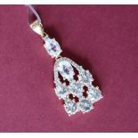 Gemporia - A 9ct gold zircon and white sapphire pendant,