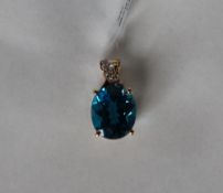 Gemporia - A 9ct gold blue topaz and diamond pendant, set with oval blue topaz and round diamonds,