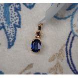 Gemporia - A 9ct gold nilamani and blue sapphire pendant,