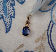 Gemporia - A 9ct gold nilamani and blue sapphire pendant,