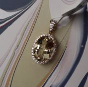 Gemporia - A 9ct gold serenite and white zircon pendant,