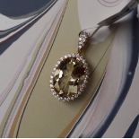 Gemporia - A 9ct gold serenite and white zircon pendant,