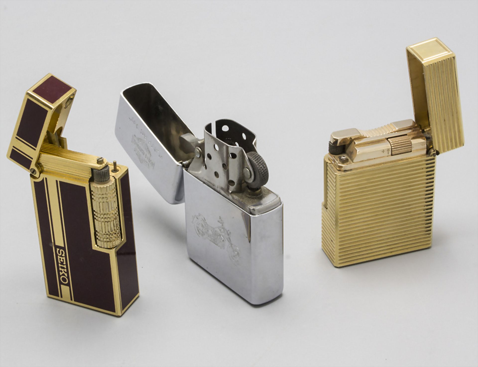 Konvolut 3 Feuerzeuge / A set of 3 lighters, 20. Jh.