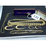 9 ct yellow gold: an Edwardian lyre stick pin set with pearls, in case; a rope-twist necklace; two