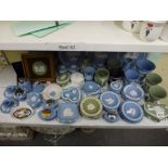 A shelf of mainly Wedgwood green and blue Jasperware china comprising plates, vases, candlesticks,