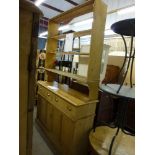 A Victorian pine kitchen dresser with display shelves above a base of two drawers and cupboards.