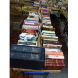 Books: on two tables and in eight boxes below, part of a library of hardback and paperback books,