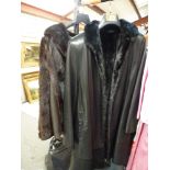 A high quality black leather and mink-lined three-quarter length coat, sold together with a brown