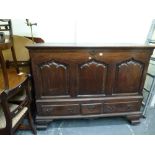 An impressive 18th century mahogany mule chest the hinged lid above three-panelled front and three