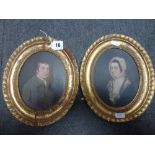 A pair of early 19th century oil on card portraits of a lady and gentleman (each oval 16.5 x 13 cm),