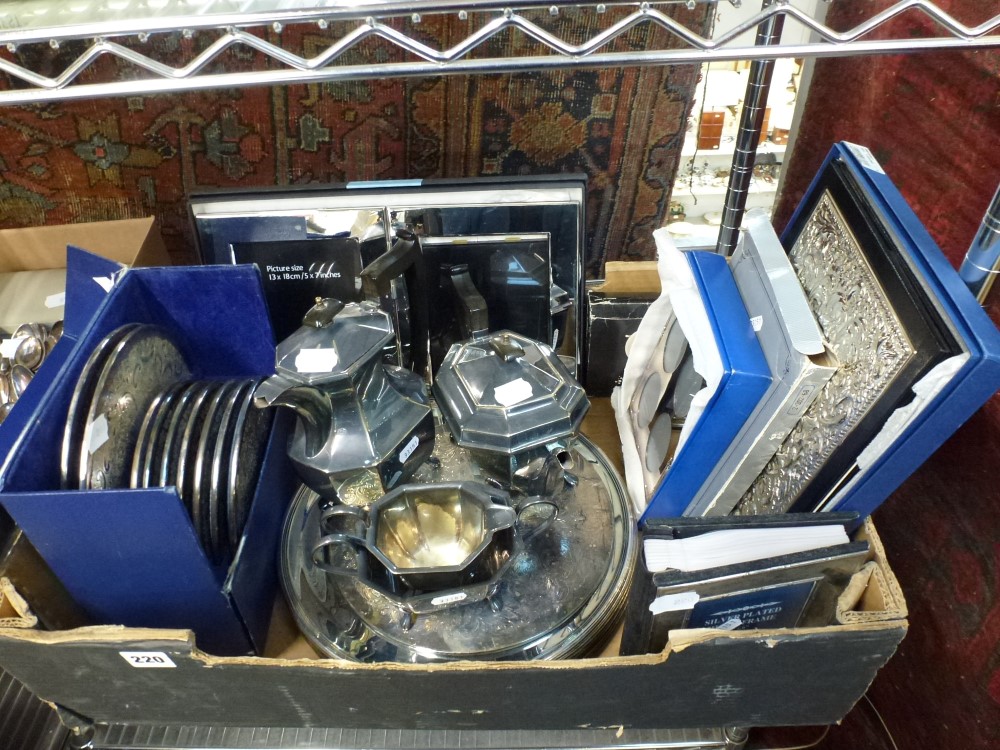 A carton of silver-plated items, including place mats, modern photograph frames, under-plates, etc.,