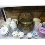 Five shelves of mixed kitchen wares including jelly moulds, part coffee services, storage jars and