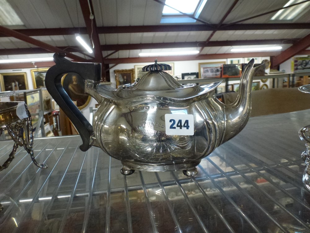 A silver teapot with black handle, engraved inscription dated 1904, 18.7 ozt gross WE DO NOT TAKE