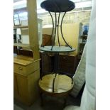 A circular walnut coffee table with quarter veneered top on cabriole legs and two metal circular