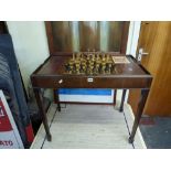 A mahogany table of rectangular form the top with a pair of red leather panels flanking an inlaid