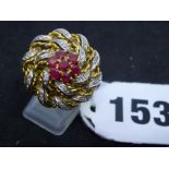 A circa 1950s cocktail ring, in yellow and white gold set with seven rubies and tiny diamonds, tests