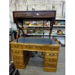 A reproduction pedestal desk in yew with blue leather top, a revolving desk chair in blue buttoned