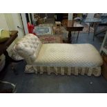 An early 20th century day bed covered in a shiny champagne coloured fabric with shell motif, with