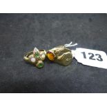 A 9 ct gold snake ring set with two opals and with green and white stones; and two other 9 ct rings,