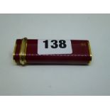 A Cartier gas lighter in burgundy lacquer with 'Trinity' band and CC monogram, no. G 26885 WE DO NOT